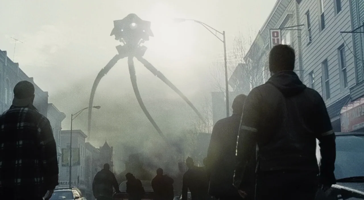 War of the Worlds (2005) movie still: wide — A city street filled with thick smoke and overcast skies during daylight. A large three-legged…