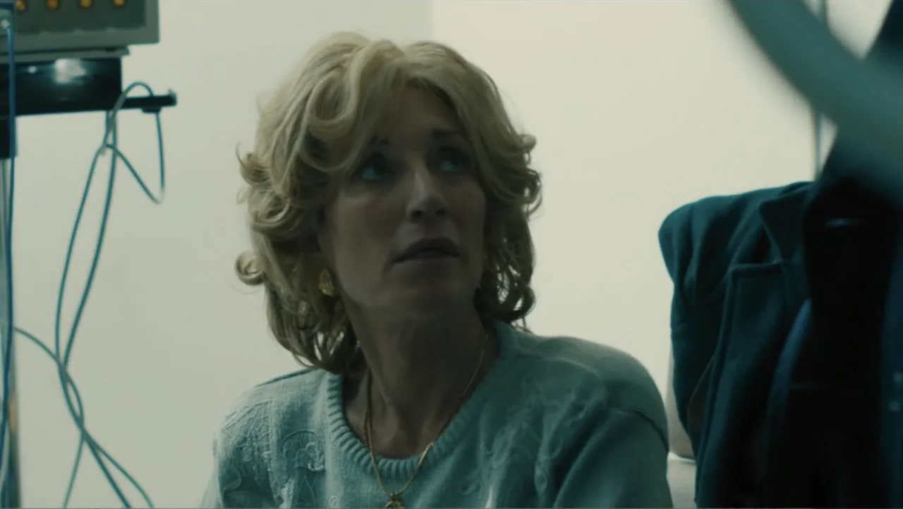 Bleed for This (2016) movie still: medium — A sterile room with medical monitoring equipment visible in the background against white walls. A blonde…