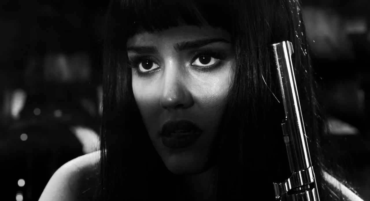 Sin City: A Dame to Kill For (2014) movie still: closeup — A dimly lit room with high-contrast shadows emphasizing a character's face. A woman…