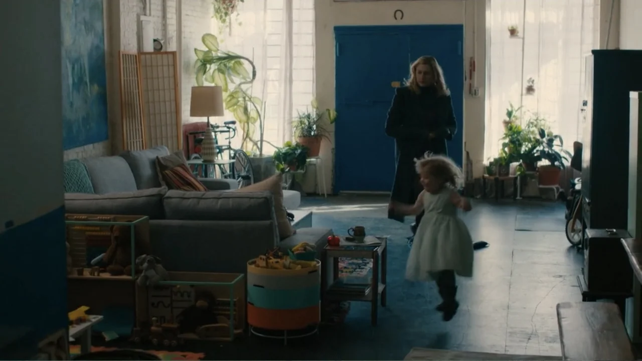Maggie's Plan (2016) movie still: wide — A spacious sunlit loft apartment features white brick walls, large windows, and colorful toys. A young girl…