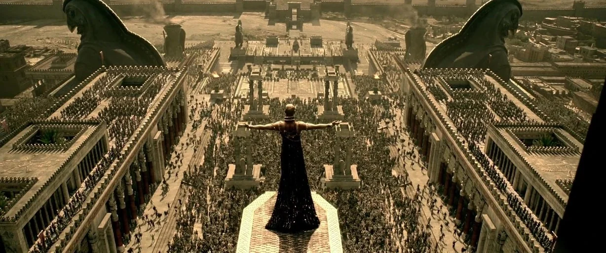 300: Rise of an Empire (2014) movie still: wide — A massive ancient stone palace courtyard filled with a vast crowd of people. A single figure in a…