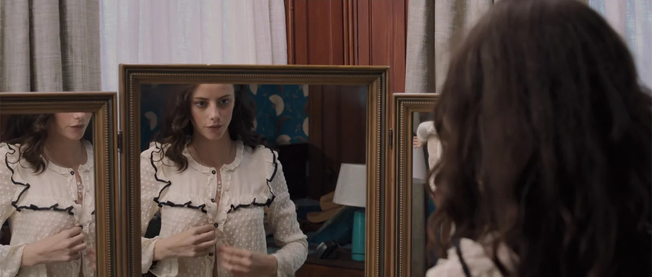 The Truth About Emanuel (2013) movie still: medium — A bedroom contains a three-paneled dressing mirror and patterned wallpaper. A young woman…