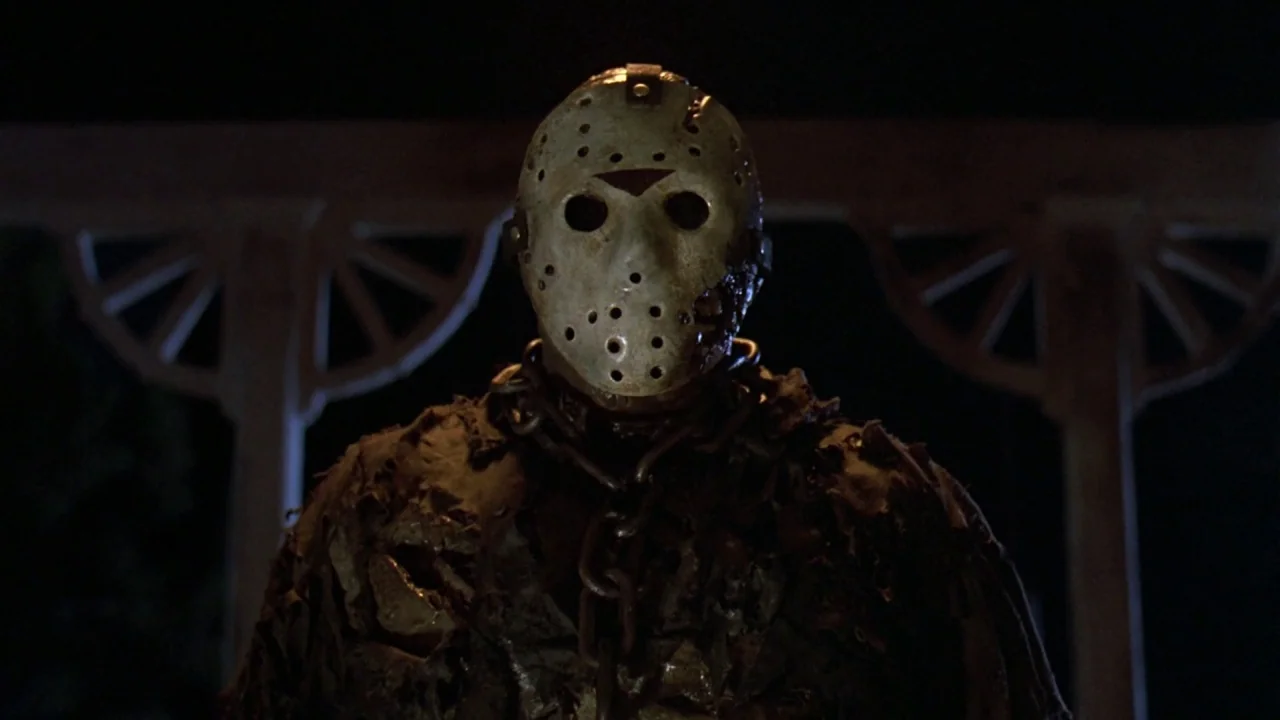 Friday the 13th Part VII: The New Blood (1988) movie still: medium — A dark night exterior features a wooden gazebo structure with arched lattice…