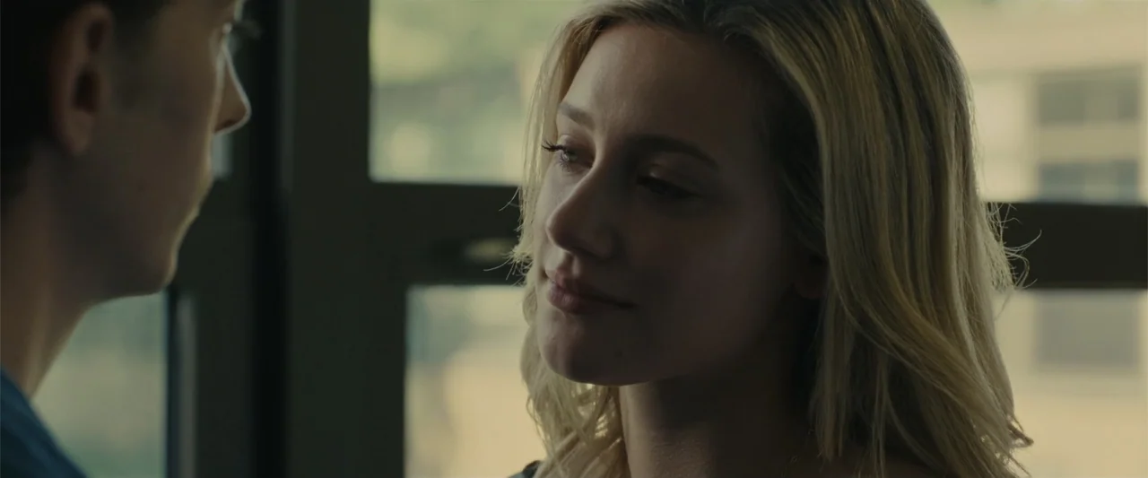 Chemical Hearts (2020) movie still: closeup — An interior classroom setting features a large window with multiple panes in the background. A young…