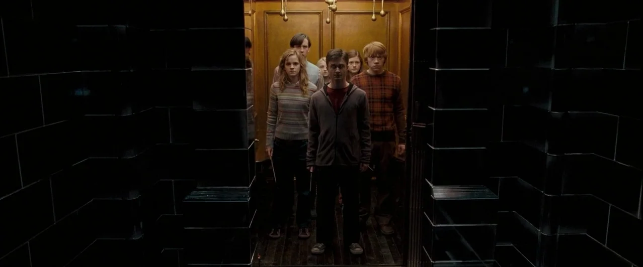 Harry Potter & The Order of the Phoenix (2007) movie still: medium — A wooden interior elevator panelled with gold detail and hanging overhead light…