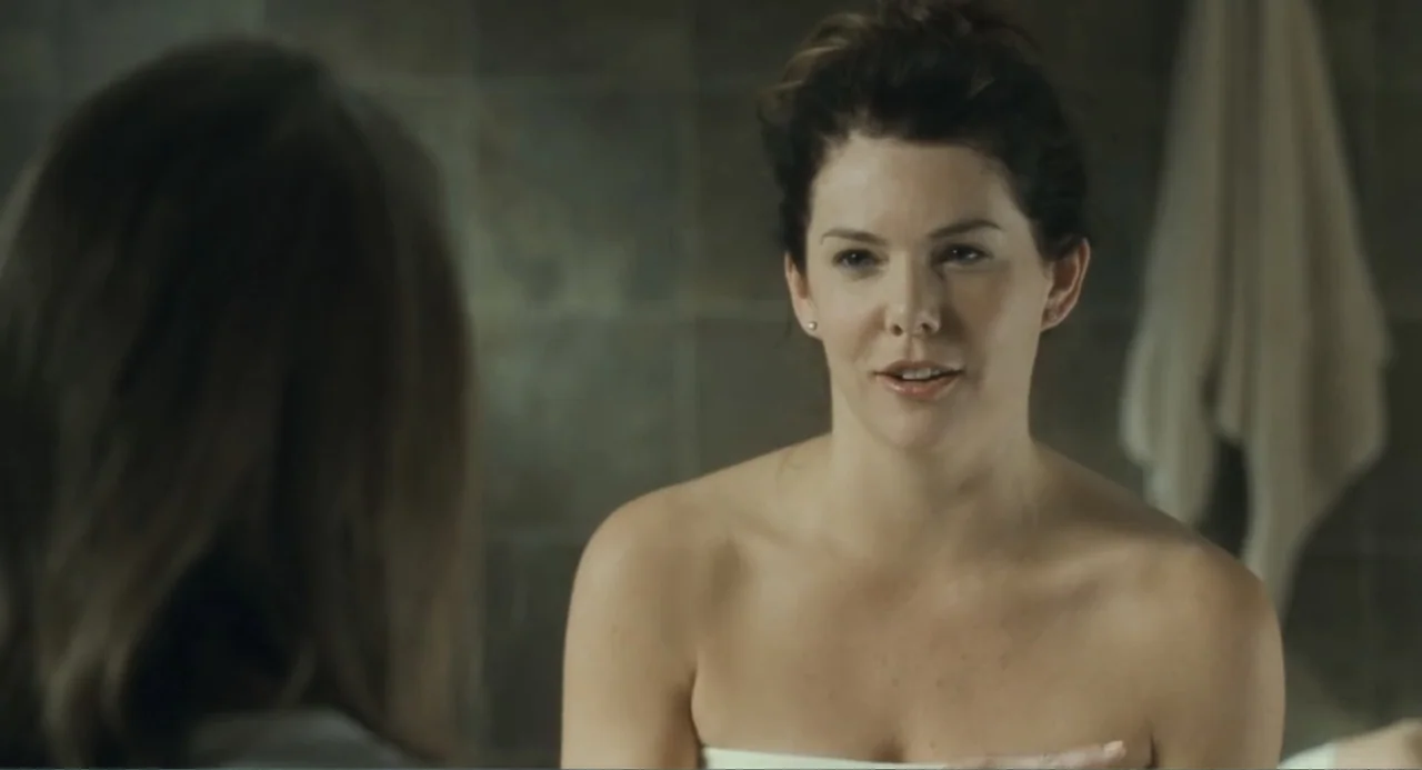 Because I Said So (2007) movie still: medium — A tiled bathroom interior with a mirror reflecting the subject's face. A woman wrapped in a white…