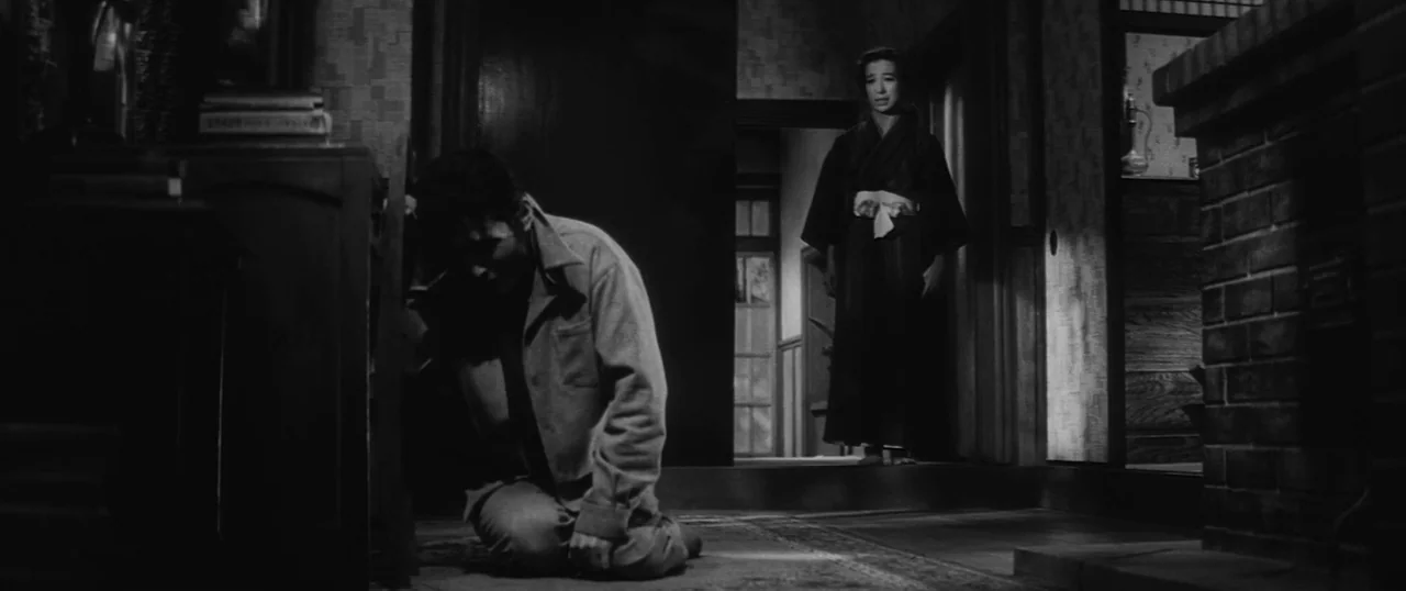 The Human Condition I: No Greater Love (1959) movie still: medium — A dark interior of a traditional Japanese home with sliding doors and textured…