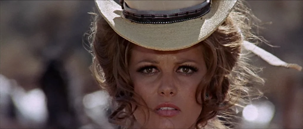 Once Upon A Time In The West (1968) movie still: closeup — An arid, sun-drenched outdoor environment with blurred, out-of-focus desert terrain in…