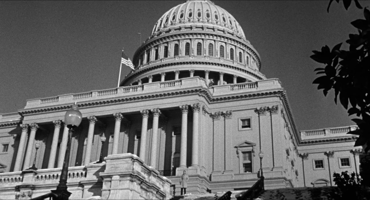 The Fearmakers (1958) movie still: establishing — The United States Capitol building features neoclassical architecture with a prominent dome and…