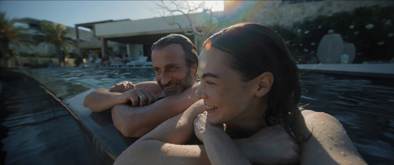 Bardo: False Chronicle of a Handful of Truths (2022) movie still: medium — A modern outdoor swimming pool edge at sunset is framed against a villa…