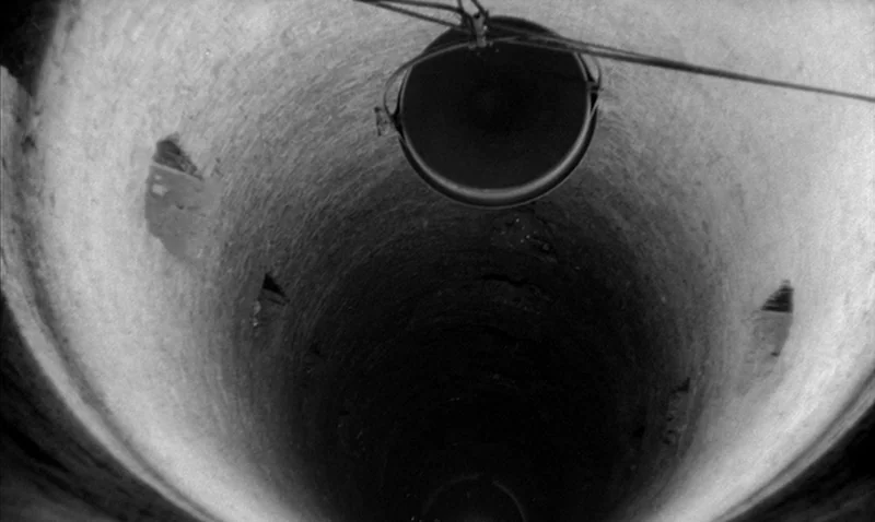 Love Affair, or the Case of the Missing Switchboard Operator (1967) movie still: establishing — A vertical stone cylinder descends into deep…