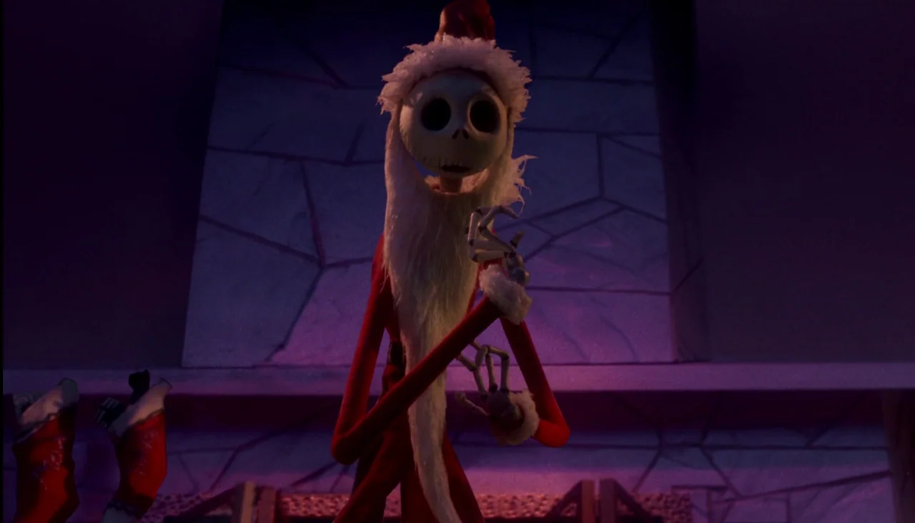 The Nightmare Before Christmas (1993) movie still: medium — A tall skeletal figure dressed as Santa stands before a large stone-textured wall. He…