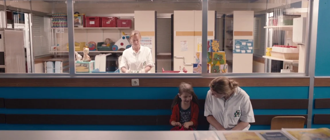 Broken Circle Breakdown (2012) movie still: medium — A hospital hallway features a glass-partitioned supply room and a horizontal blue wall trim. A…