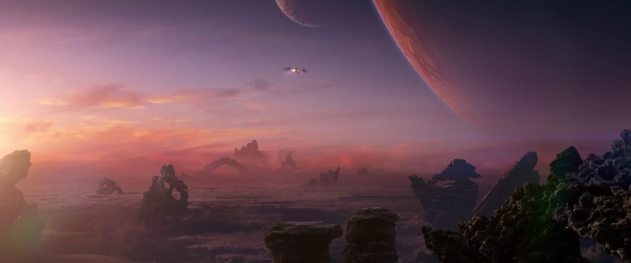 Guardians of the Galaxy (2014) movie still: establishing — A rugged alien planet features jagged rock formations rising from a low-lying mist. Two…