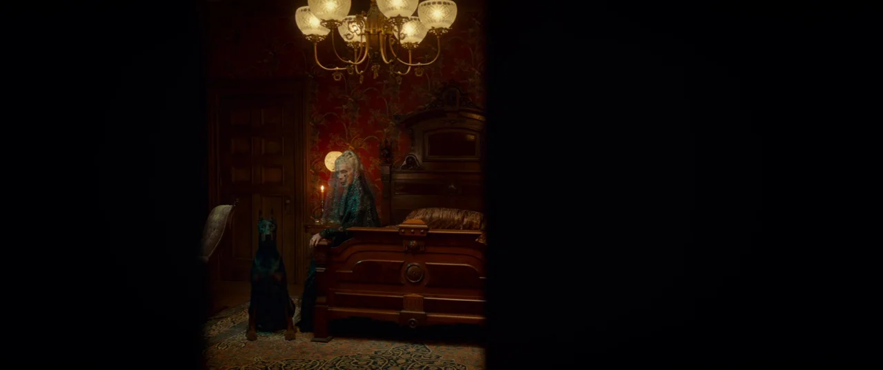 Scary Stories to Tell in the Dark (2019) movie still: wide — A dark bedroom features heavy red damask wallpaper and polished antique mahogany…