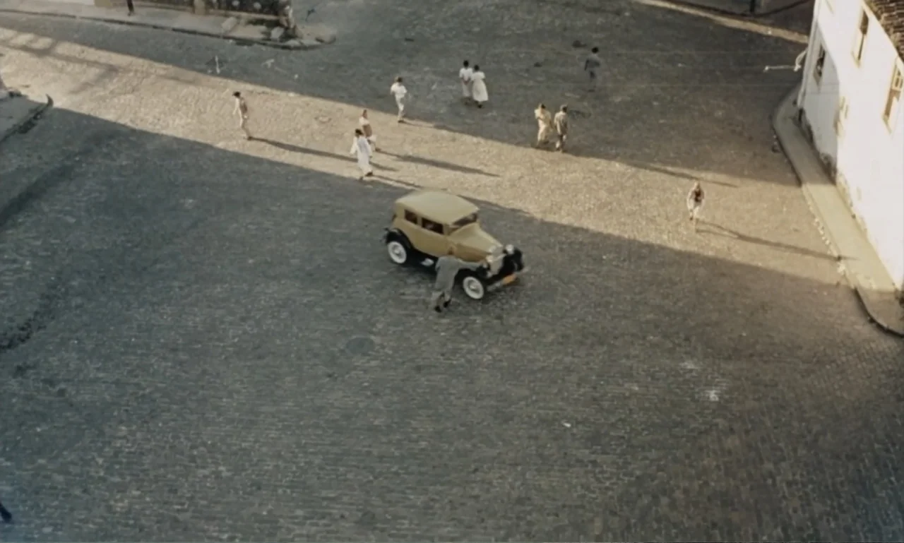Dona Flor and Her Two Husbands (1976) movie still: establishing — A stone-paved European plaza from the early twentieth century contains several…