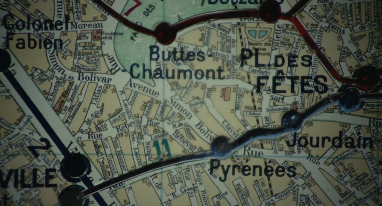 Le Samouraï (1967) movie still: closeup — A close-up view of a vintage street map displaying various roads and metro lines. Text labels indicate…