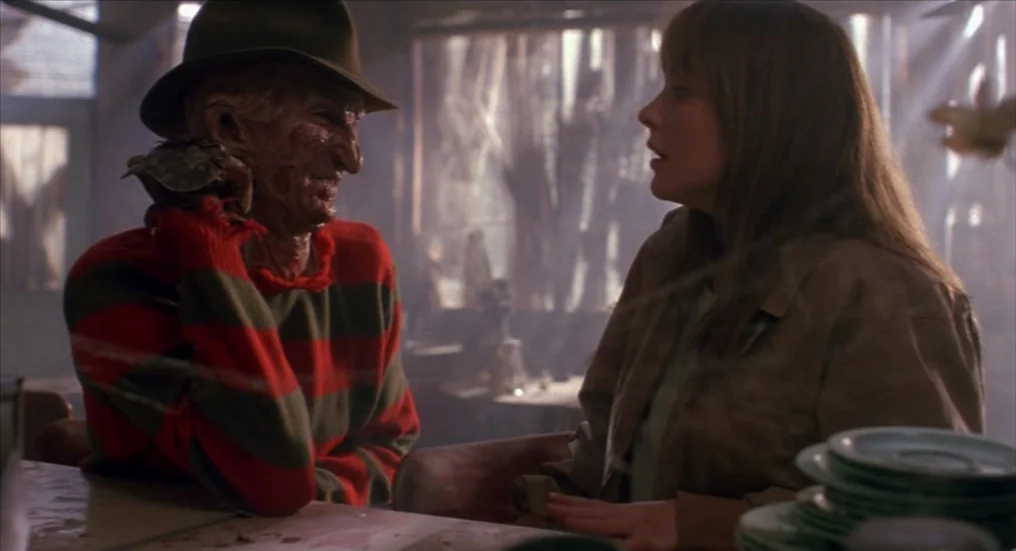 A Nightmare On Elm Street 4: The Dream Master (1988) movie still: medium — A dimly lit diner booth interior features light filtering through dusty…