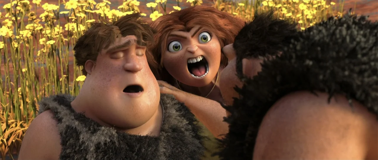 The Croods (2013) movie still: medium — A field of tall yellow wildflowers serves as the backdrop for three animated figures. A young woman shouts…