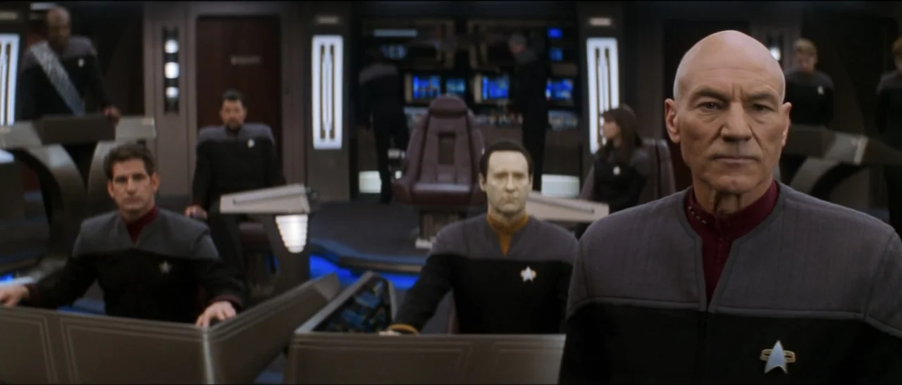 Star Trek: Nemesis (2002) movie still: medium — A high-tech control deck features multiple consoles with glowing blue screen interfaces and…