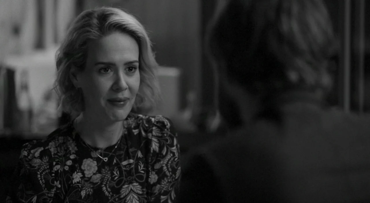 Blue Jay (2016) movie still: medium — A table in a dimly lit restaurant during evening hours. A woman sits looking at an out-of-focus individual.