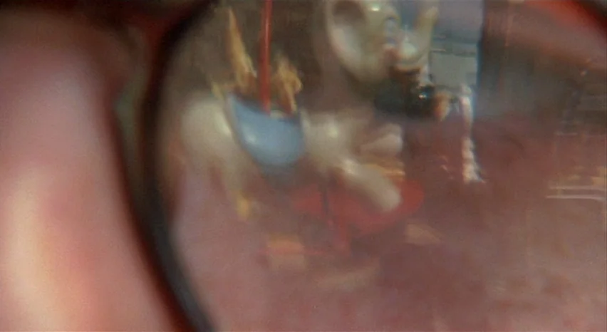 A Safe Place (1971) movie still: closeup — A close-up view shows the extreme detail of an iris reflecting an external object. The reflection…