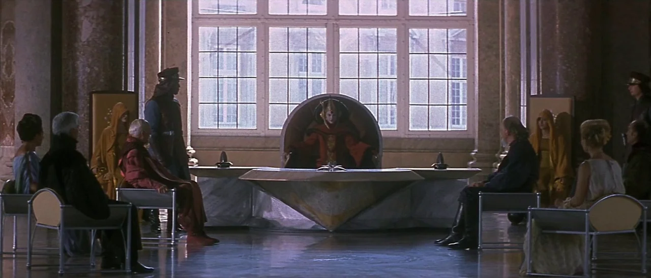 Star Wars: Episode I – The Phantom Menace (1999) movie still: wide — A spacious room features a large window, stone columns, and minimalist metal…