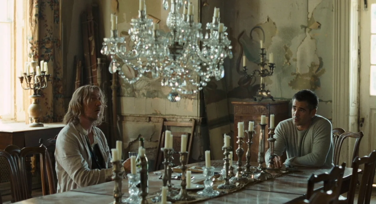 London Boulevard (2010) movie still: medium — An aging, dilapidated room features peeling wallpaper and a grand crystal chandelier overhead. Two men…