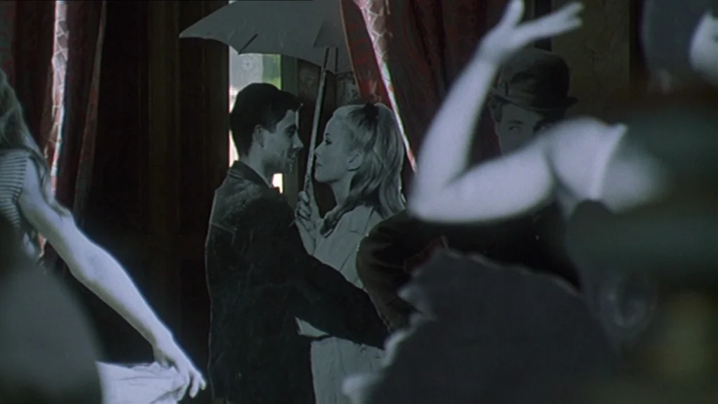 One Hundred and One Nights (1995) movie still: medium — A dark indoor space features heavy drapes and a partially visible cutout of a man. A young…
