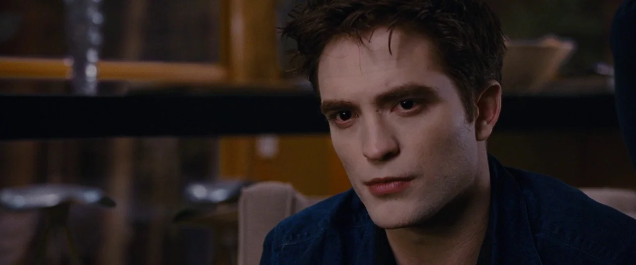 The Twilight Saga: Breaking Dawn – Part 1 (2011) movie still: closeup — A modern dining area with muted tones and blurred background furniture…