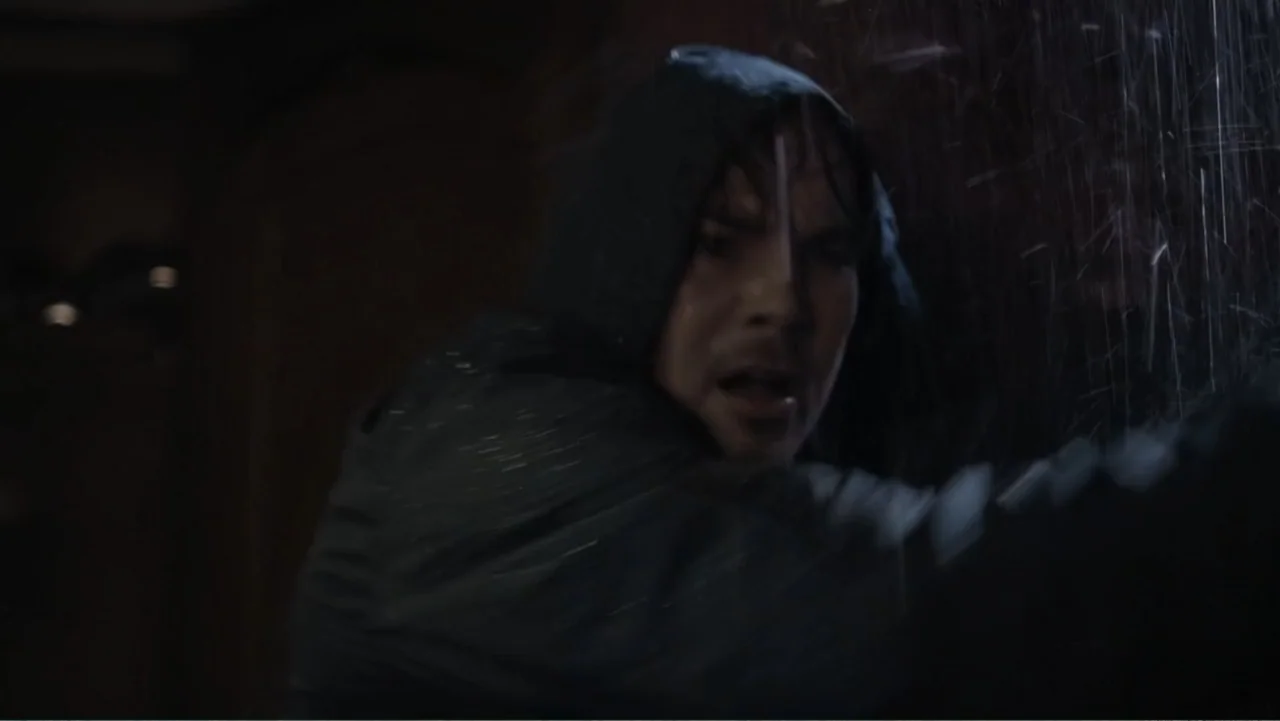 Capsized: Blood in the Water (2019) movie still: closeup — A dark, rain-drenched outdoor environment at night with low visibility. A man with a wet…