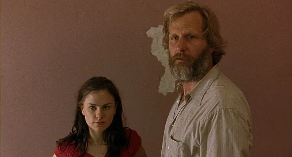 The Squid and the Whale (2005) movie still: medium — A man and woman stand before a plain wall with a patch of peeling paint. They remain stationary…