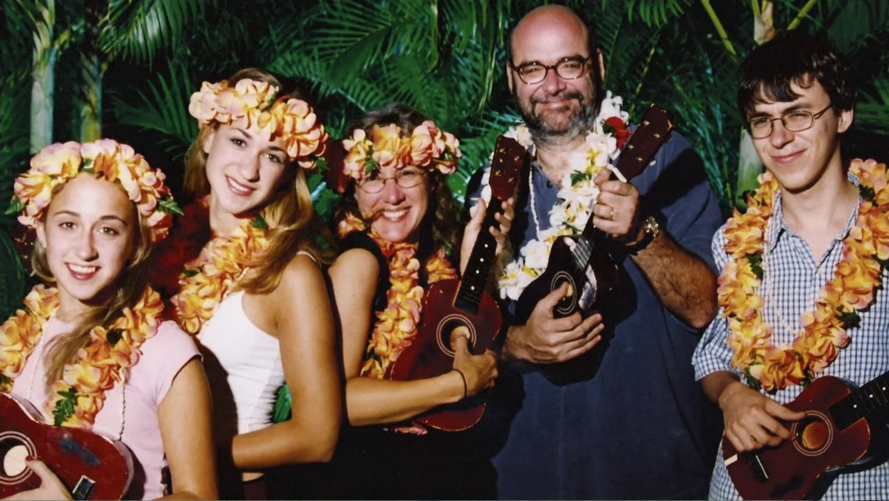 When Strangers Click: Five Stories from the Internet (2011) movie still: medium — A group of five people poses in front of palm fronds at night.…