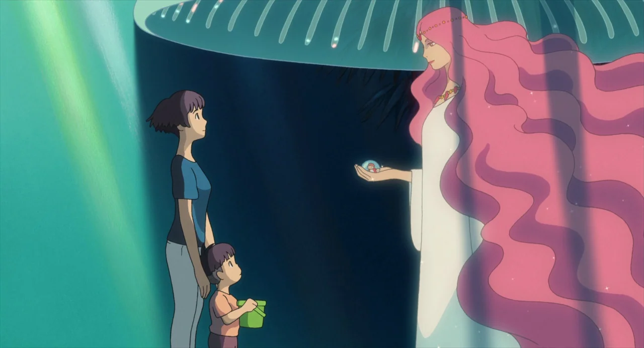 Ponyo (2008) movie still: wide — A woman and a young boy stand on the dark ocean surface at night. A giant goddess with long pink hair emerges from…