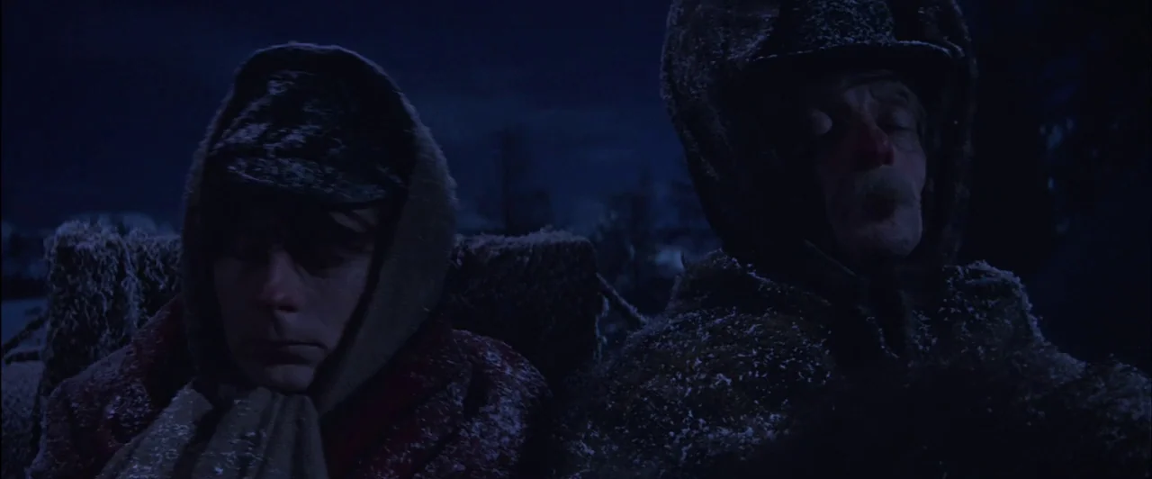 The Fearless Vampire Killers (1967) movie still: medium — A dark, snow-covered landscape serves as the backdrop for two men in a sleigh. The men are…