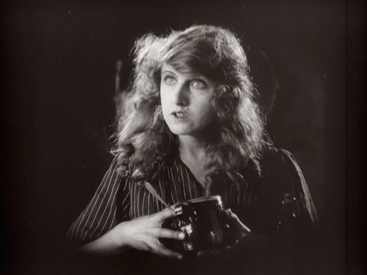Making of: The Wheel (La Roue) (1923) movie still: medium — The subject stands against a dark, featureless background in a studio-lit space. A young…