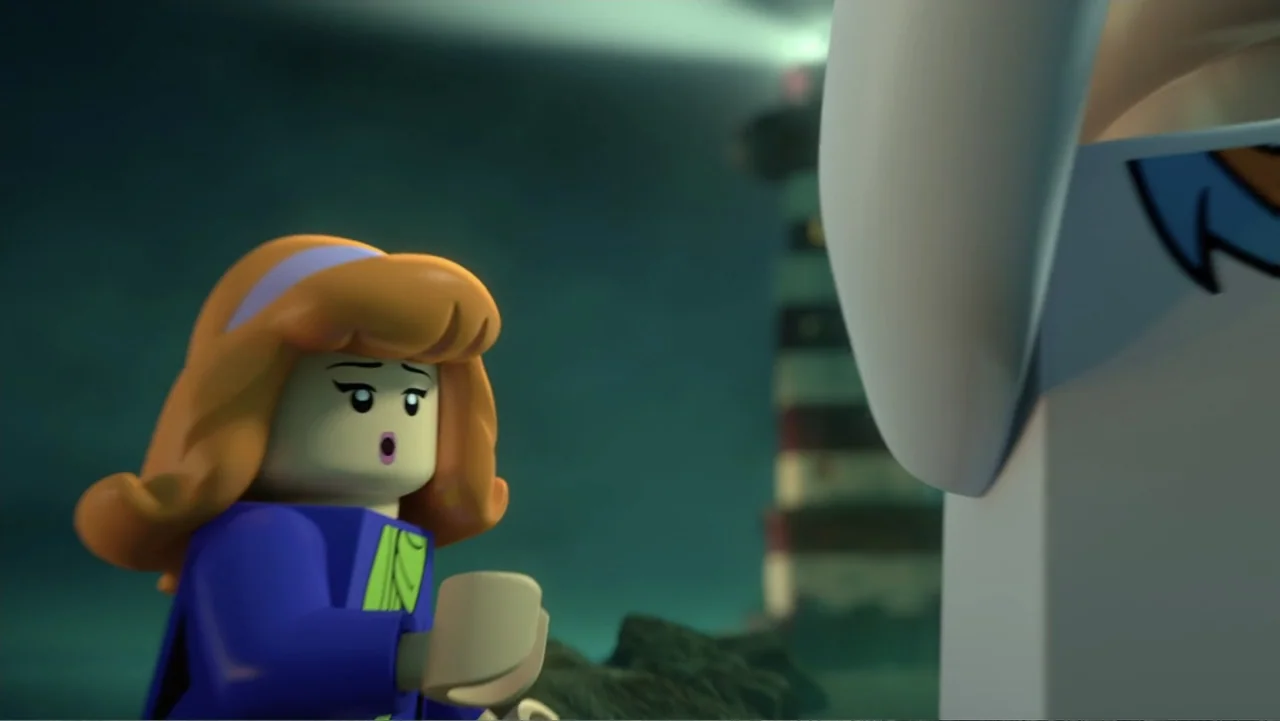 LEGO Scooby-Doo! Haunted Hollywood (2016) movie still: medium — A rocky coastline at night features a lighthouse beam sweeping through the dark air.…