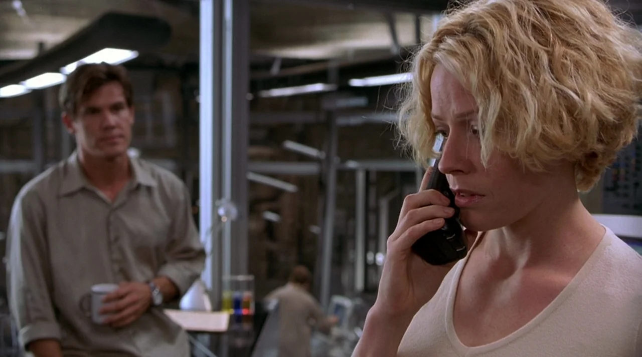 Hollow Man (2000) movie still: medium — A modern laboratory with metal support structures and lab equipment visible in the background. A woman talks…