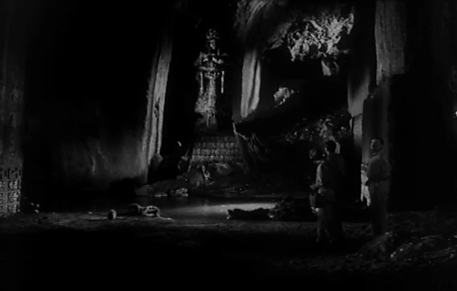 Caltiki, The Immortal Monster (1959) movie still: wide — A vast, dark subterranean cavern features a small central pool and an ornate carved statue.…