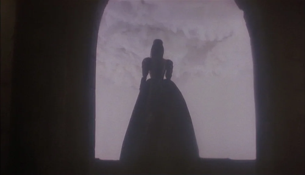 Bram Stoker’s Dracula (1992) movie still: fullbody — A dark stone archway frames a view of a cloudy, overcast sky. A woman wearing a long,…