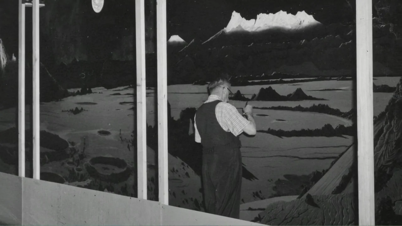 Chesley Bonestell: A Brush with the Future (2018) movie still: medium — An artist stands before a large detailed mural depicting a cratered lunar…