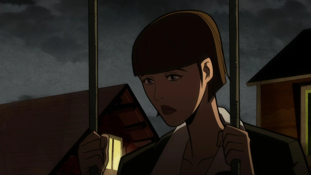 Batman: The Long Halloween, Part One (2021) movie still: medium — A woman stands in a playground at night with dark houses in the background. She…