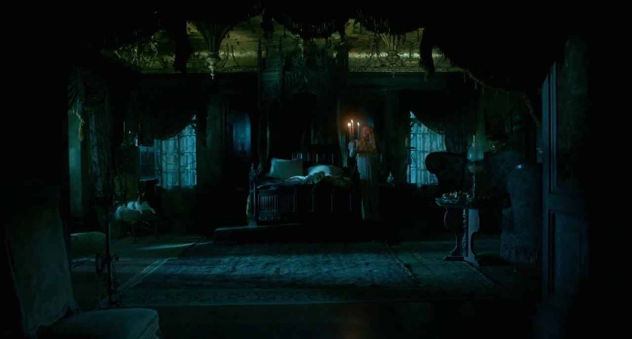 Crimson Peak (2015) movie still: wide — A dark, ornate Victorian bedroom with heavy drapes and a canopy bed. A young woman in a white nightgown…
