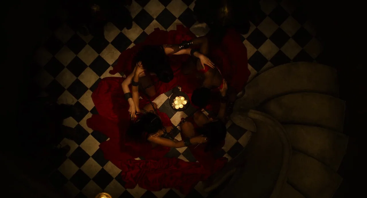 The Immortals (2011) movie still: wide — A dark chamber features a black and white checkerboard floor and stone staircase elements. Four figures in…