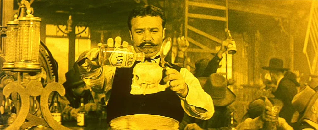 Lemonade Joe (1964) movie still: medium — A crowded nineteenth-century drinking establishment contains patrons in hats and western attire. A…