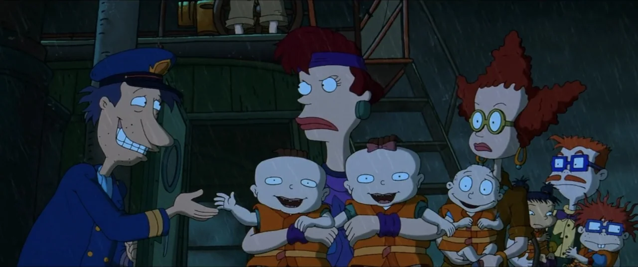 Rugrats Go Wild (2003) movie still: medium — A dark boat deck at night during a rainstorm with metallic surfaces visible. A man in a blue captain…