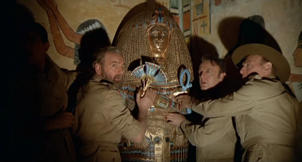 Blood From The Mummy’s Tomb (1971) movie still: medium — A dark subterranean space features walls covered with detailed ancient Egyptian relief…