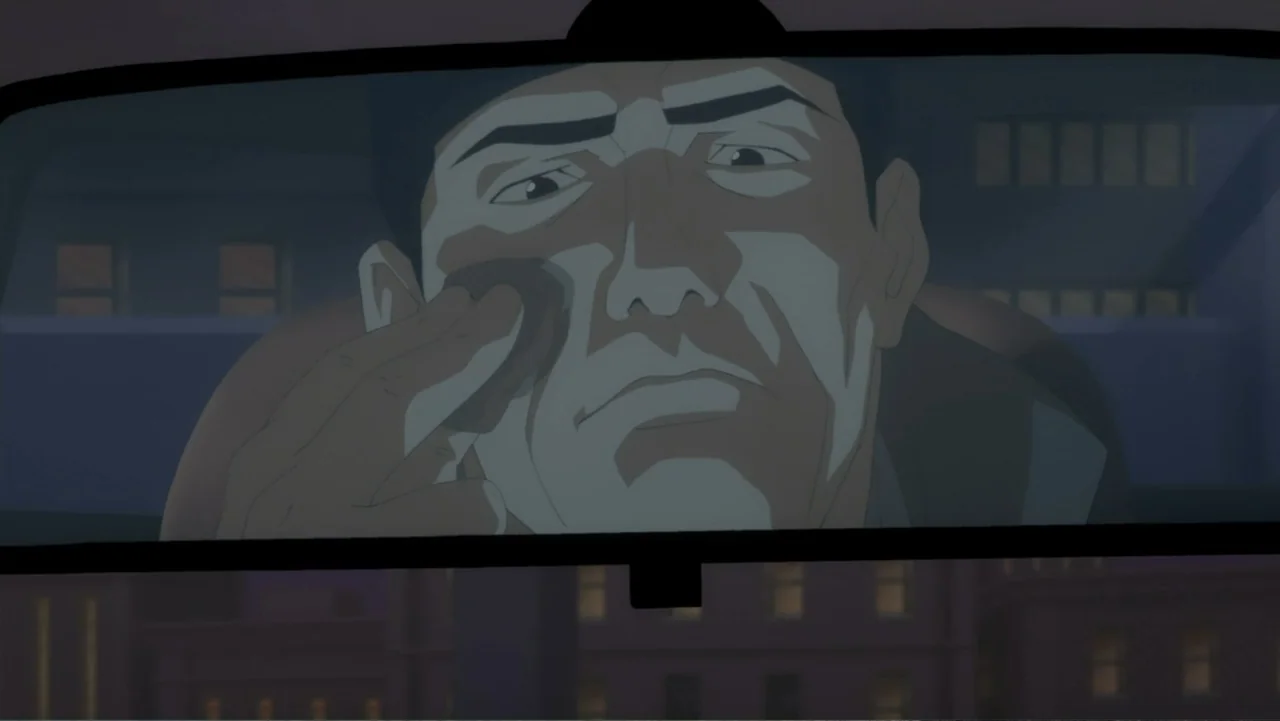 Batman: Year One (2011) movie still: closeup — A man looks into a car rearview mirror at night. He uses a small sponge to apply cosmetic foundation…