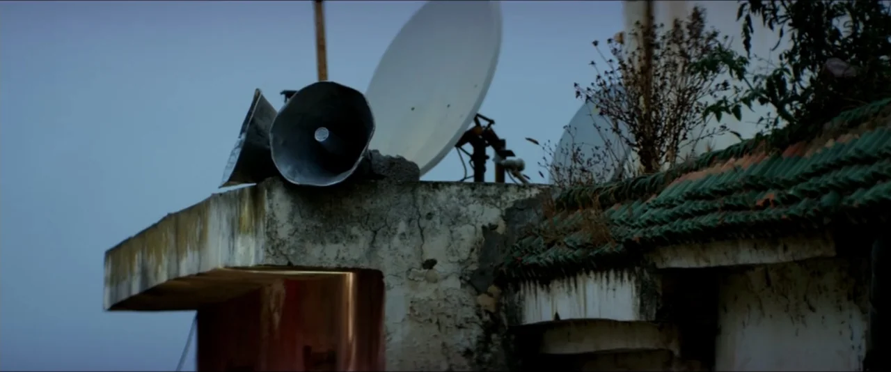 13 Hours: The Secret Soldiers of Benghazi (2016) movie still: establishing — A weathered concrete roof terrace features a satellite dish and a large…