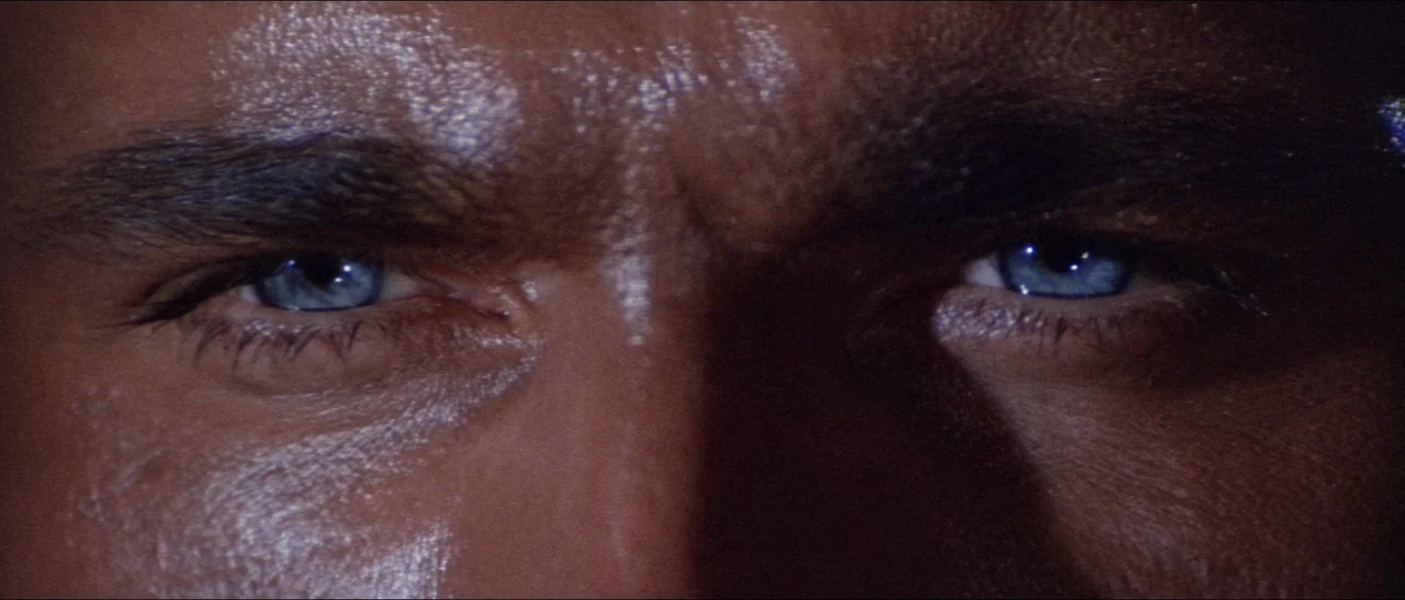 Texas, Adios (1966) movie still: closeup — A tight closeup of a man's eyes and brow. The skin surface is shiny with visible sweat and pores.